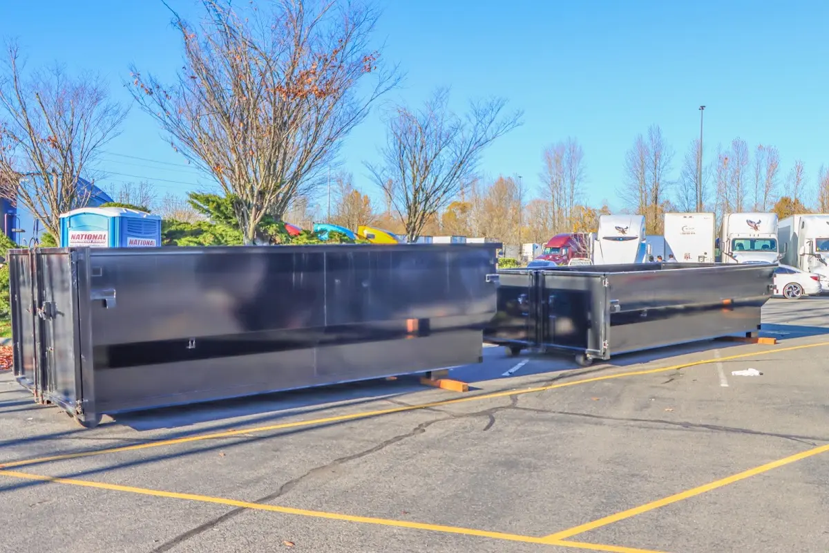 Professional dumpster rental service with roll-off container on residential driveway in Buena Vista